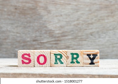 Letter block in word sorry on wood background