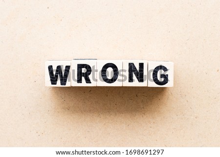 Letter block in word wrong on wood background
