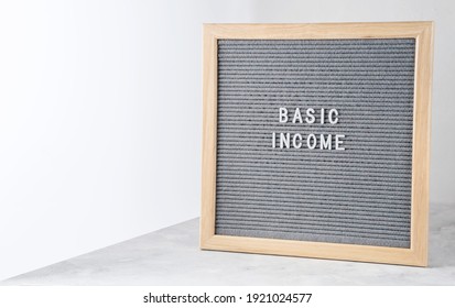Letter board with words Basic Income. Announcement government support program