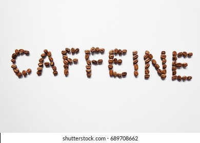 Letter of CAFFEINE arranged with coffee beans on white background with some space for your text