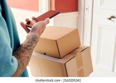 Letter Carrier Checks An Order With His Mobile Phone