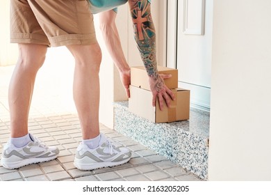 Letter Carrier Leaves Boxes In Front Of A Door