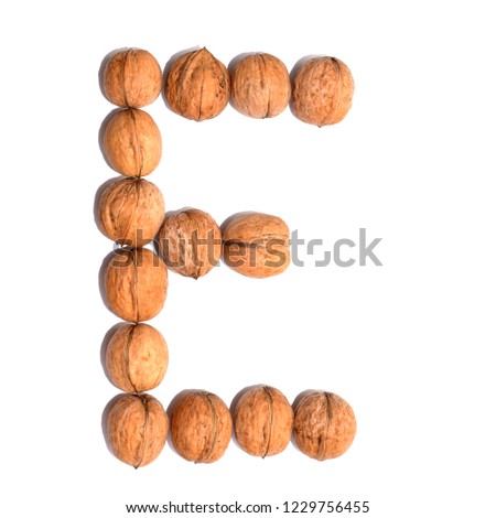 Letter E made with nuts to form a letter of the alphabet. Fruit letters on a white background.