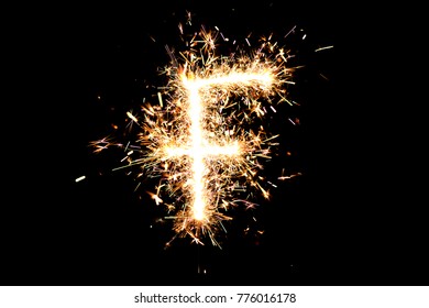 Letter "F" made of sparklers isolated background. 
