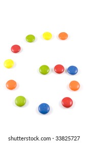 Letter G Made Of Colored Smarties, Isolated Over White