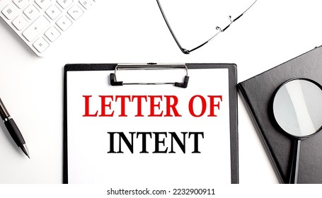 LETTER OF INTENT text written on a paper clipboard with office tools - Shutterstock ID 2232900911