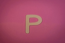 Letter P In Wood On A Pink Background