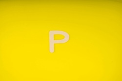 Letter P In Wood On Yellow Background