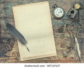 Letter Paper And Vintage Writing Tools. Feather Pen, Inkwell, Keys On Textured Wooden Background. Retro Style Toned Picture