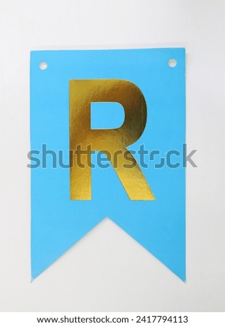 Letter R uppercase - golden color font on blue background