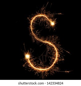 Letter "S" sparklers on black background