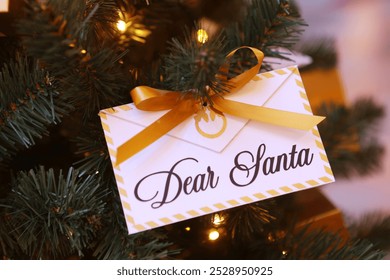 Letter for Santa Claus. Christmas letter is hanging on the tree. An envelope with the inscription Santa Claus. - Powered by Shutterstock