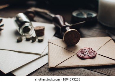 Letter seal with wax seal stamp on the wood table. Vintage notary stamp and sealed envelope. Post concept. Sealing wax. Wax seal. Dark academia style. Scandinavian hygge styled composition. - Shutterstock ID 1894693255