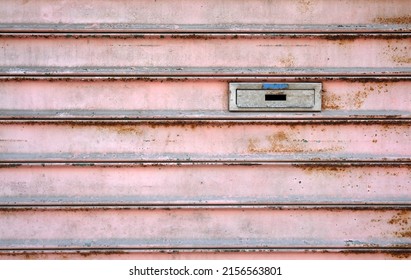 Letterbox On A Weathered Metal Door