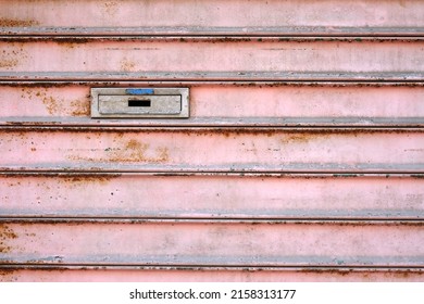 Letterbox On A Weathered Metal Door