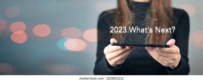 Lettering 2023 what's next? Girl holding a tablet in her hand - Shutterstock ID 2233051211