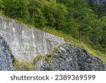 Lettering Aare Gorge at entrance of Landmark on a cloudy late summer day. Photo taken September 19th, 2023, Grimsel, Canton Bern, Switzerland.