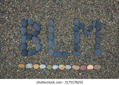 Lettering BLM Black lifes matter made from stones.. Concept of stopping racism