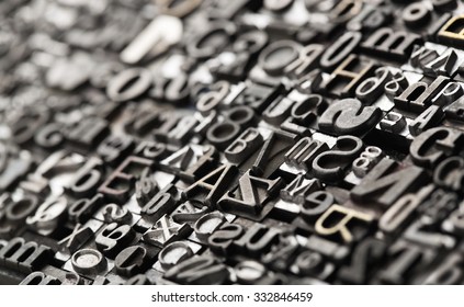 Letterpress background, close up of many old, random metal letters with copy space - Shutterstock ID 332846459