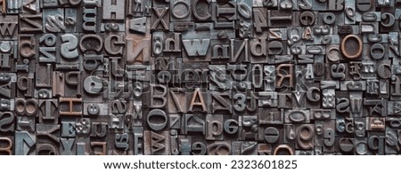 Letterpress background, close up of many old, random metal letters with copy space
