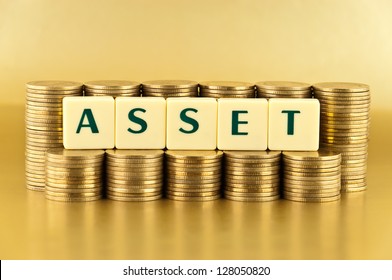 The Letters  ASSET With Stacks Of Coins On Gold Background