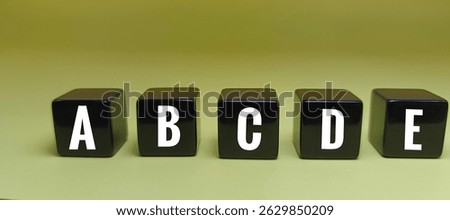 Letters A B C D E on Black Dice – Educational Alphabet Concept Representing Basic Literacy, Language Learning, Typography, and Communication Symbols. 