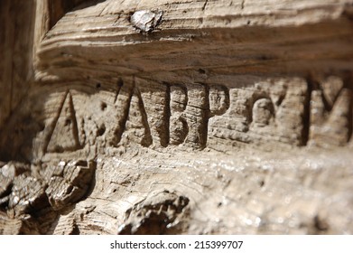 Letters carved into wooden door