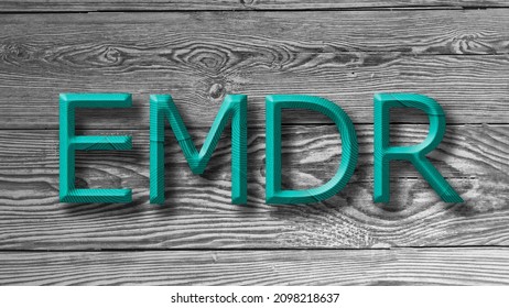 Letters EMDR written on wooden gray background. Eye Movement Desensitization and Reprocessing psychotherapy treatment concept. - Shutterstock ID 2098218637