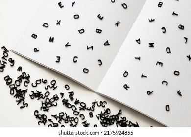 Letters Of The English Alphabet Are Scattered On A Blank White Sheet, Grammar And Spelling, Learning Foreign Languages, TOEFL Test