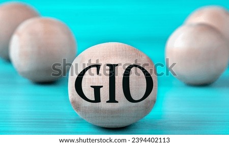 The letters GIO ( Graphics Input Output) are depicted on a wooden round ball on a blue background. Technology concept
