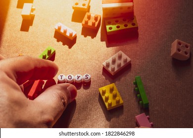 The letters lined up in the word toys, with puzzle toys dotted around them, and the orange sun lit up. - Powered by Shutterstock