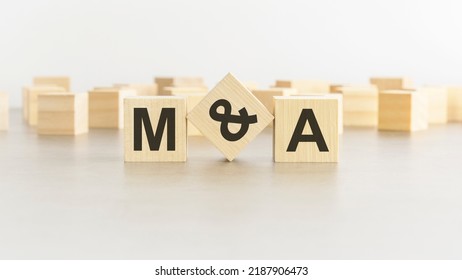 Letters M And A On Wooden Blocks, White Background