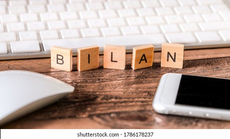 Letters on wooden pieces concept, business background, french word "bilan" means balance sheet - Shutterstock ID 1786178237