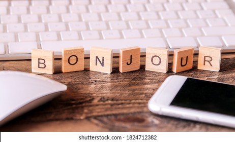 Letters on wooden pieces concept, business background, french word "Bonjour" means Hello
