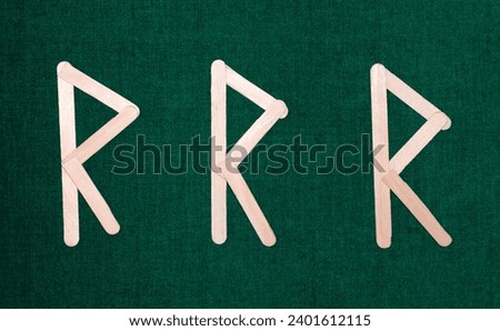 letters 'R, R, R' made from recycled material (ice cream sticks) with green background, initials of the words recycle, reuse and reduce [[stock_photo]] © 