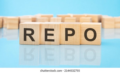 letters REPO made with wood building blocks. blue background. business concept