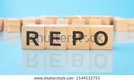 letters REPO made with wood building blocks. blue background. business concept