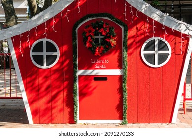 Letters To Santa. Holiday Shopping And Christmas Cheer In Austin Texas USA With A Red , Green , And White Santa House With Slot To Leave Santa A Christmas Letter