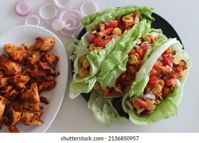 Lettuce Chicken Wrap. Tandoori Chicken Bites, Sauteed Baby Corn, Fresh Cut Tomatoes And Onions Tossed And Wrapped In Iceberg Lettuce Leaves. Shot On White Background