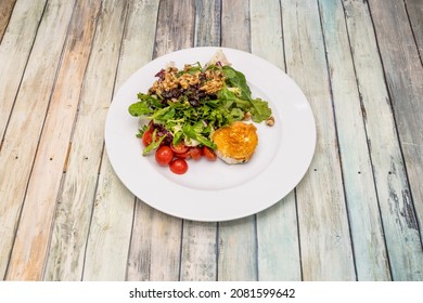 Lettuce Salad With Cherry Tomatoes, California Walnuts And Raisins With Fried Goat Cheese