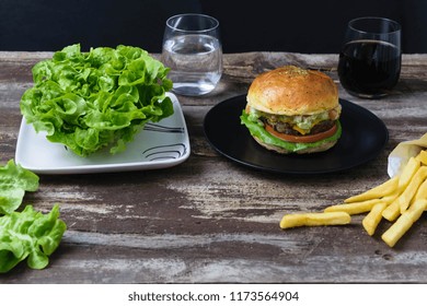 Letucce Versus Hamburger Fries. Water Or Soda. Healthy Vs Unhealthy Concept