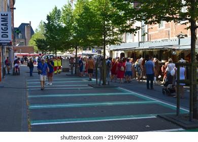 Leuven, Flemish-Brabant, Belgium - September 05, 2022:  Monday Market, People And Rescue Workers Red Cross Fluorescent Yellow Clothes Walking In Lei Street. They Are Always Present With Much Folks 