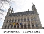 Leuven Town Hall in city center. Barbantine late gothic building with several flags including European, Belgian and Flemmish. Historic building in the Brabant province, in Flanders, Belgium.