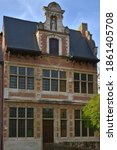 Leuven, Vlaams-Brabant Belgium- November 24, 2020: heritage Grand  Beguinage Leuven. Started construction 13th century. Unesco World Heritage Site. Brick house built in 16th century. Statue on top of