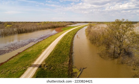 Levee road with flooding on both sides. On the right hand side is flood water from Yazoo River. On the left hand side is backwater flooding. - Shutterstock ID 2233824421