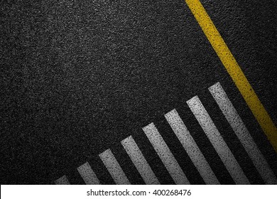 Level asphalted road with a dividing stripes and pedestrian crossing. The texture of the tarmac, top view. - Shutterstock ID 400268476