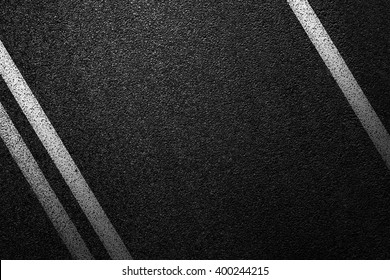 Level asphalted road with a dividing white stripes. The texture of the tarmac, top view. - Shutterstock ID 400244215
