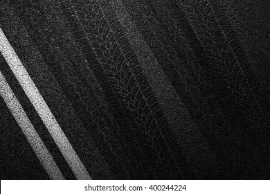 Level Asphalted Road With A Dividing White Stripes And Tyre Tracks. The Texture Of The Tarmac, Top View.