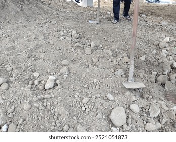 level the ground using a hoe for the base layer of the house floor.