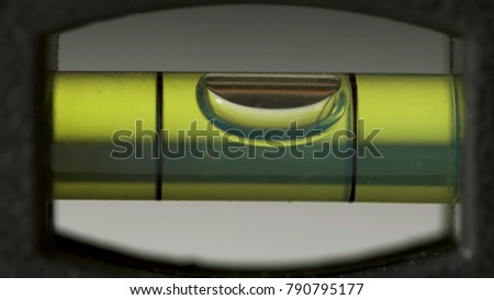 Leveling instrument's bubble closeup. Carpenter's spirit level macro. Buildings and construction level